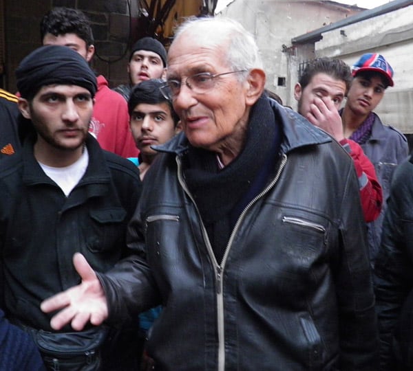 Jesuit Father Frans van der Lugt, who had worked in Syria since 1966, is seen talking with civilians in January. (CNS/Reuters)