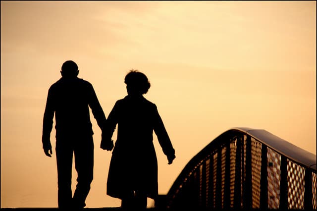 couple walking on bridge